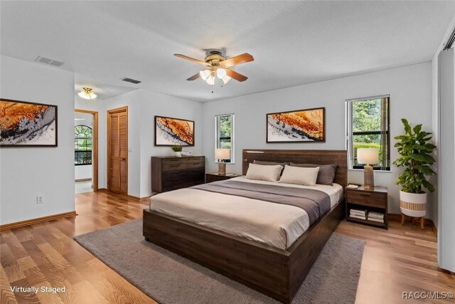 2494 W Axelwood Dr, Beverly Hills, FL 34465 - bedroom with visible vents, baseboards, a ceiling fan, a closet, and light wood finished floors