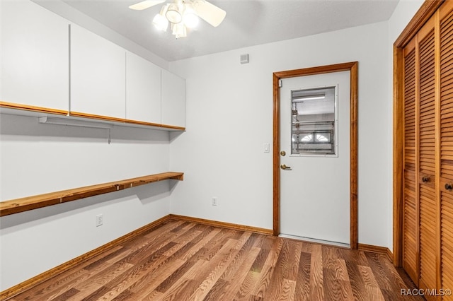 clothes washing area with hardwood / wood-style flooring and ceiling fan