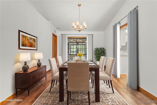 2494 W Axelwood Dr, Beverly Hills, FL 34465 - dining room with an inviting chandelier, baseboards, and wood finished floors