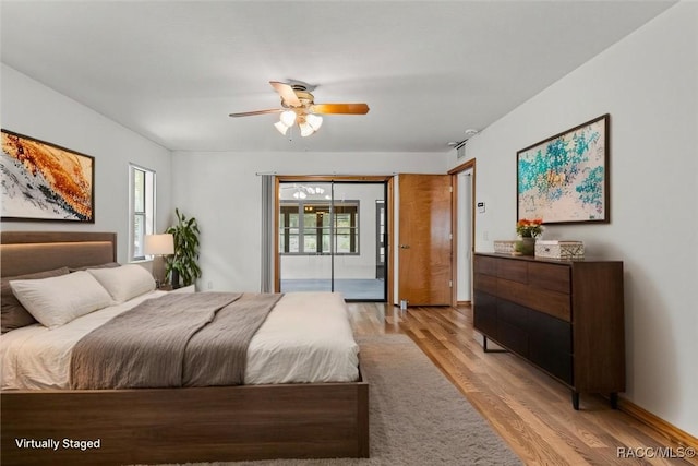 2494 W Axelwood Dr, Beverly Hills, FL 34465 - bedroom featuring a ceiling fan, multiple windows, and light wood finished floors