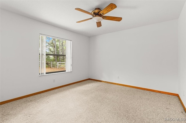 spare room featuring carpet floors and ceiling fan