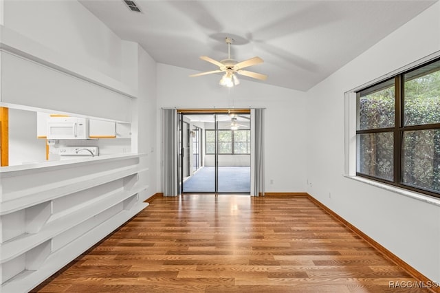 empty room with ceiling fan, lofted ceiling, and light wood-type flooring