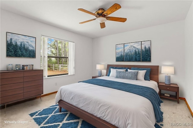 2494 W Axelwood Dr, Beverly Hills, FL 34465 - bedroom featuring a ceiling fan, light colored carpet, and baseboards