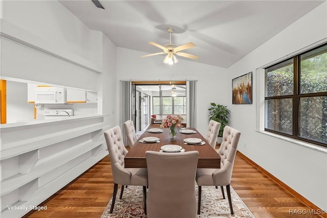 2494 W Axelwood Dr, Beverly Hills, FL 34465 - dining space with vaulted ceiling, dark wood finished floors, and a wealth of natural light