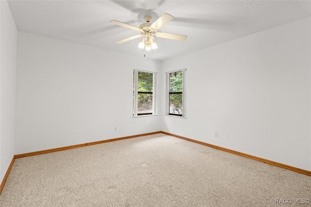 spare room featuring carpet flooring, a textured ceiling, and ceiling fan