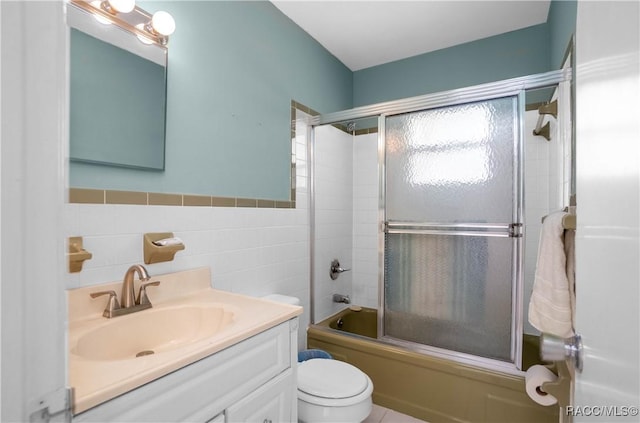728 S Juniper Way, Inverness, FL 34450 - full bath with toilet, combined bath / shower with glass door, tile walls, vanity, and wainscoting