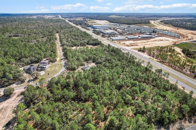 drone / aerial view with a wooded view