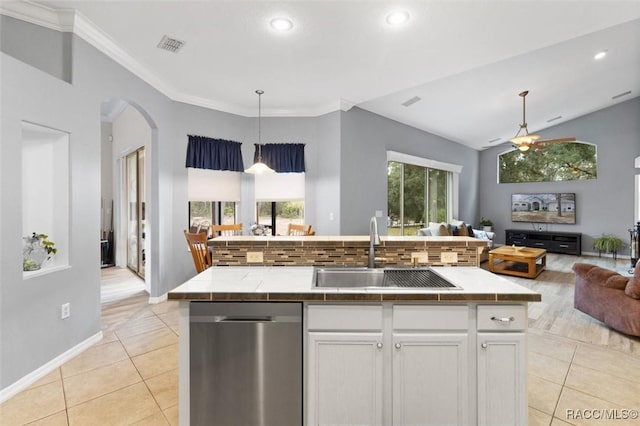 kitchen featuring dishwasher, open floor plan, a kitchen island with sink, white cabinetry, and a sink