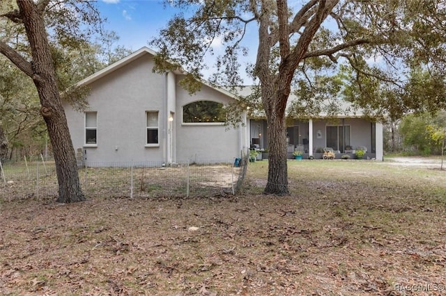 view of side of home with stucco siding