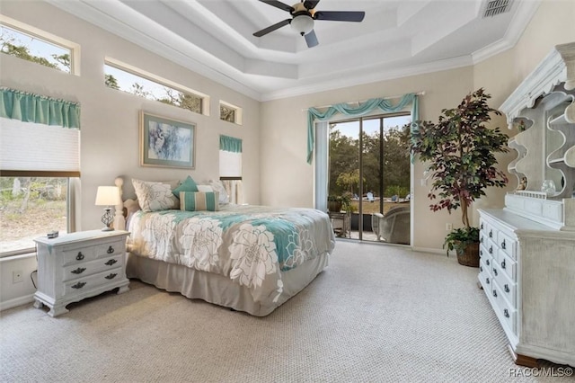 bedroom with access to exterior, visible vents, a raised ceiling, and crown molding