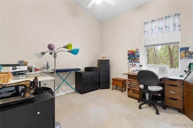 home office featuring light carpet, vaulted ceiling, and a ceiling fan