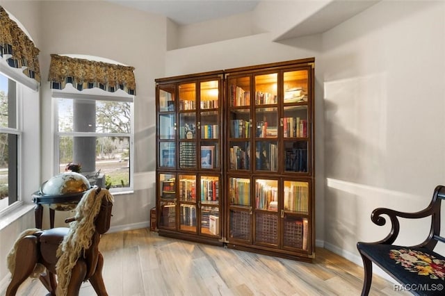 sitting room with baseboards and light wood-style floors