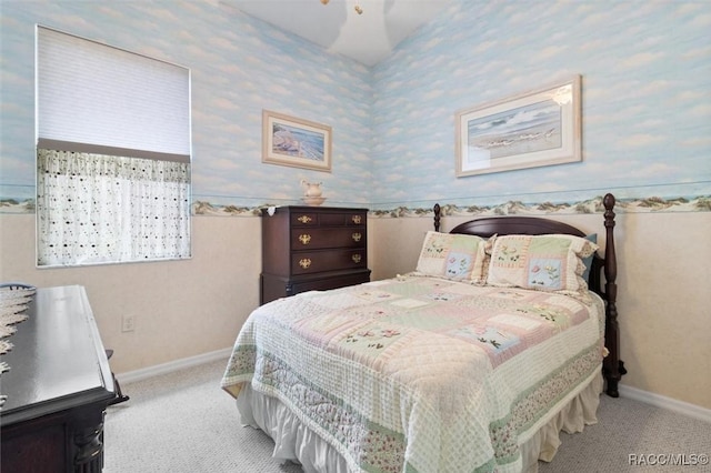 bedroom with light colored carpet, baseboards, and wallpapered walls