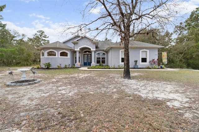 ranch-style home with stucco siding