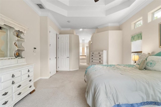 bedroom featuring light colored carpet, visible vents, baseboards, ornamental molding, and a tray ceiling