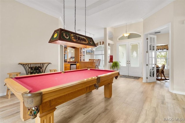 playroom featuring french doors, light wood-type flooring, and crown molding