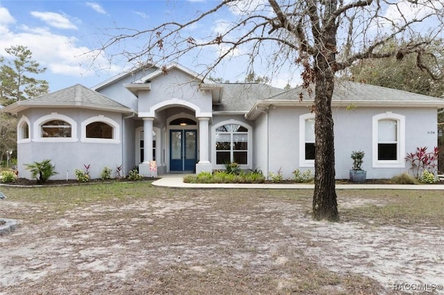 view of front of property featuring stucco siding and french doors