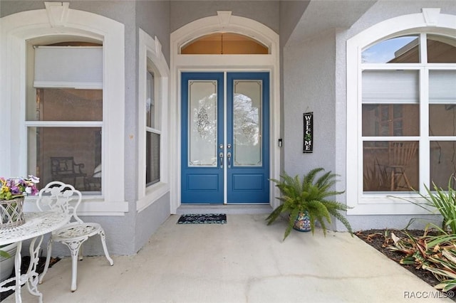 doorway to property with french doors and stucco siding