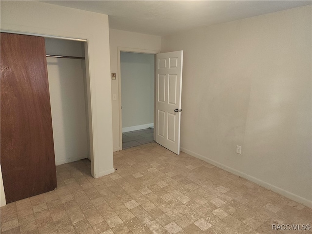 unfurnished bedroom with a closet