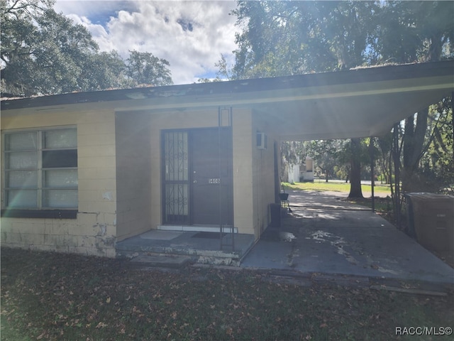 doorway to property with a carport