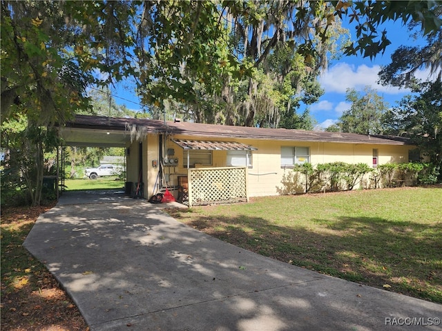 single story home featuring a front lawn and a carport