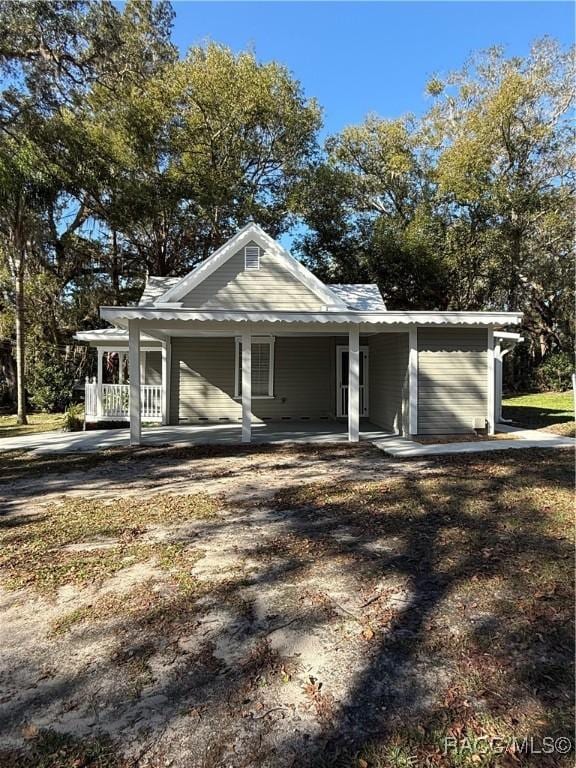 view of side of property with covered porch