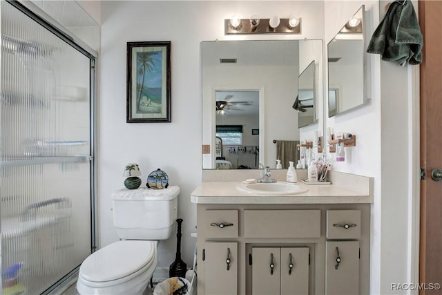 2191 S Moonlit Pt, Homosassa, FL 34448 - ensuite bathroom with toilet, a stall shower, vanity, and a ceiling fan