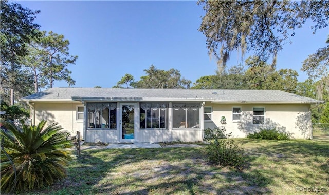 2191 S Moonlit Pt, Homosassa, FL 34448 - back of house featuring a sunroom, a yard, and stucco siding