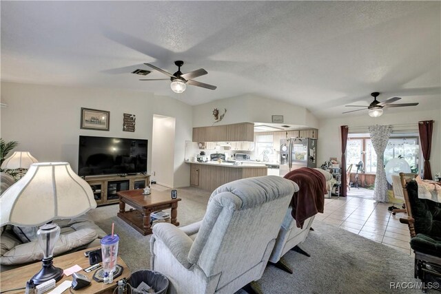 2191 S Moonlit Pt, Homosassa, FL 34448 - living area with a ceiling fan, vaulted ceiling, and light tile patterned flooring