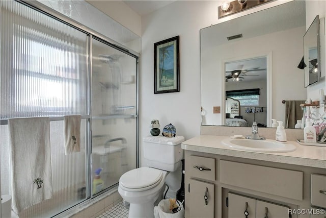 2191 S Moonlit Pt, Homosassa, FL 34448 - ensuite bathroom with a stall shower, toilet, vanity, ceiling fan, and tile patterned flooring