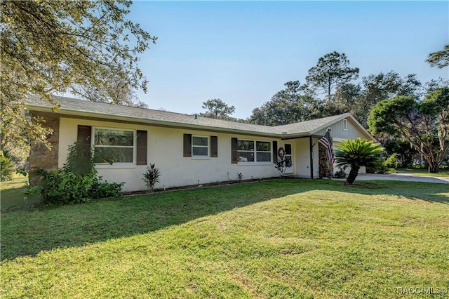 2191 S Moonlit Pt, Homosassa, FL 34448 - ranch-style home featuring concrete driveway, a front lawn, and stucco siding