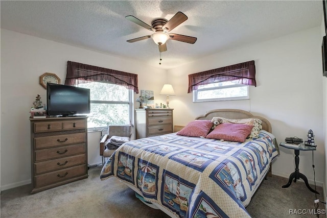 2191 S Moonlit Pt, Homosassa, FL 34448 - bedroom featuring multiple windows, carpet flooring, ceiling fan, and a textured ceiling