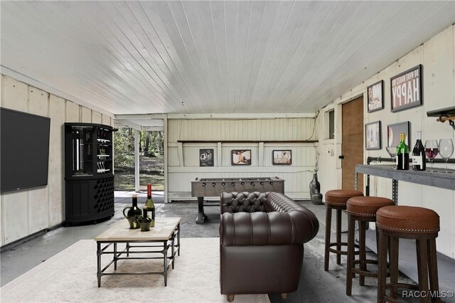 2191 S Moonlit Pt, Homosassa, FL 34448 - living room featuring concrete flooring, wooden walls, and wooden ceiling