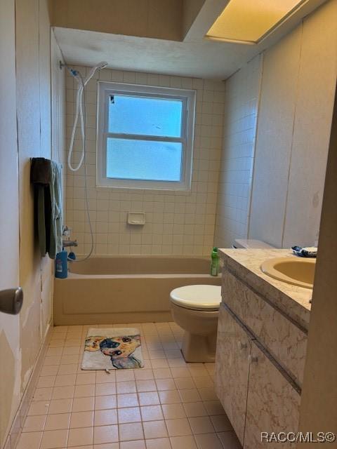 full bathroom with toilet, tile patterned flooring, washtub / shower combination, and vanity