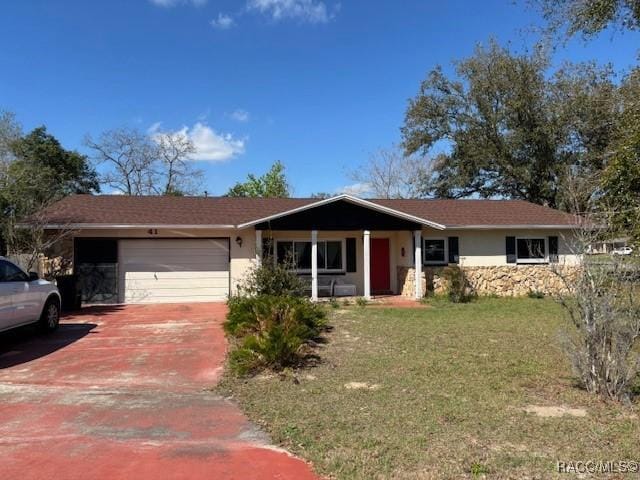 single story home with an attached garage, stucco siding, driveway, and a front yard