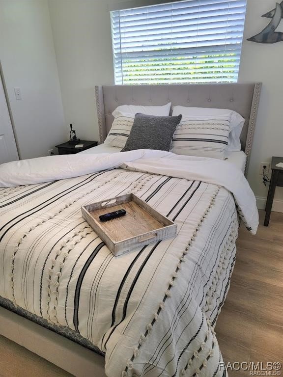 bedroom featuring wood-type flooring