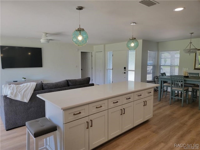 kitchen with white cabinets and decorative light fixtures