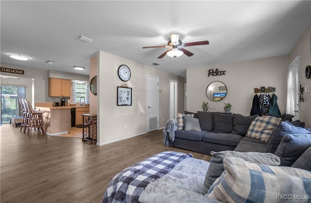 living room with ceiling fan and dark hardwood / wood-style flooring