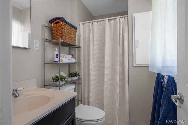 bathroom with vanity, toilet, and walk in shower