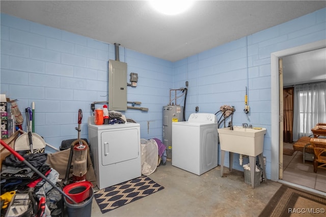 washroom featuring electric panel, washer and clothes dryer, and water heater