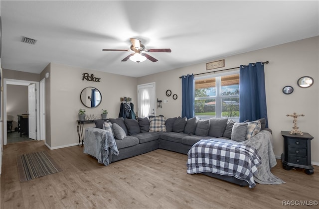 living room with light wood-type flooring and ceiling fan