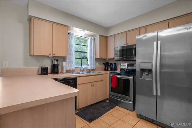 kitchen with appliances with stainless steel finishes, light brown cabinetry, and sink