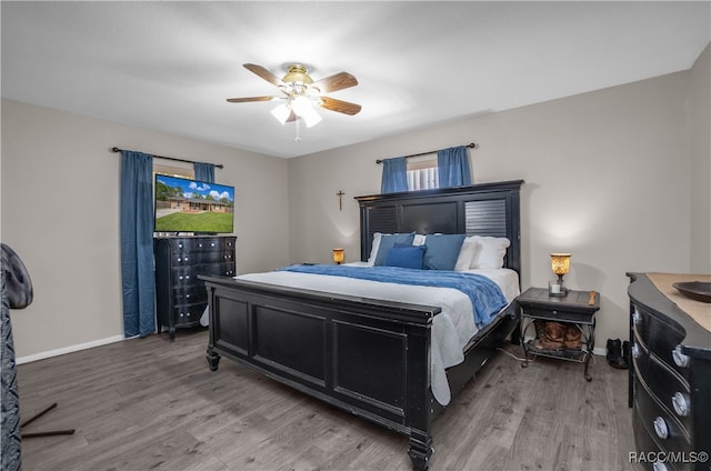 bedroom with ceiling fan and hardwood / wood-style floors