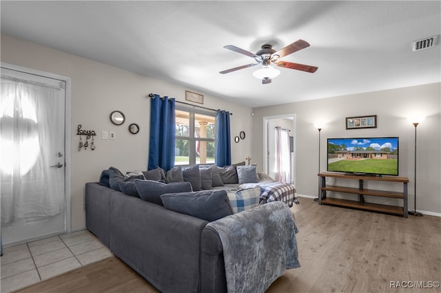 living room with ceiling fan and light hardwood / wood-style floors