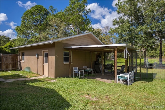 back of house with a lawn