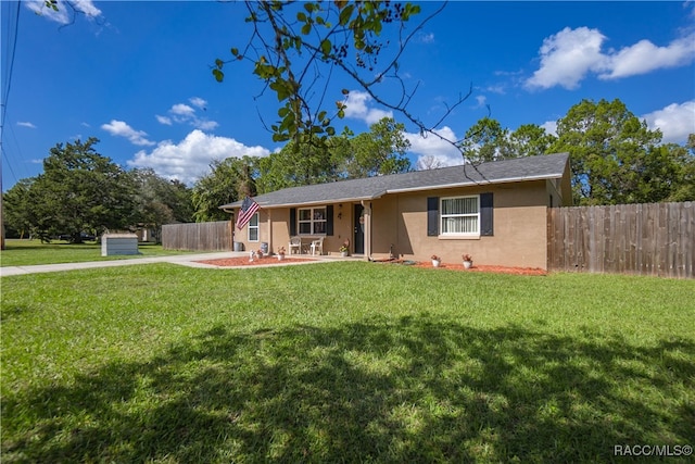 ranch-style house featuring a front lawn