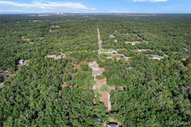 birds eye view of property with a view of trees