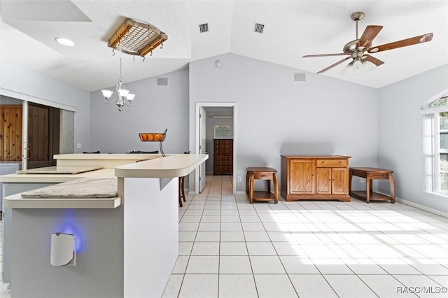 kitchen featuring visible vents, lofted ceiling, light tile patterned flooring, light countertops, and ceiling fan with notable chandelier