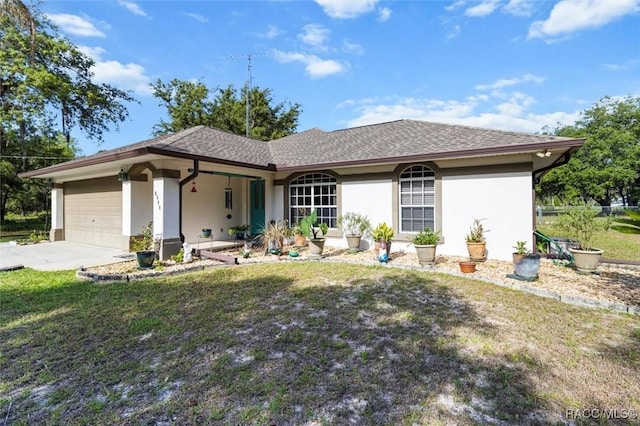 view of front of property featuring a garage, a front lawn, stucco siding, and concrete driveway