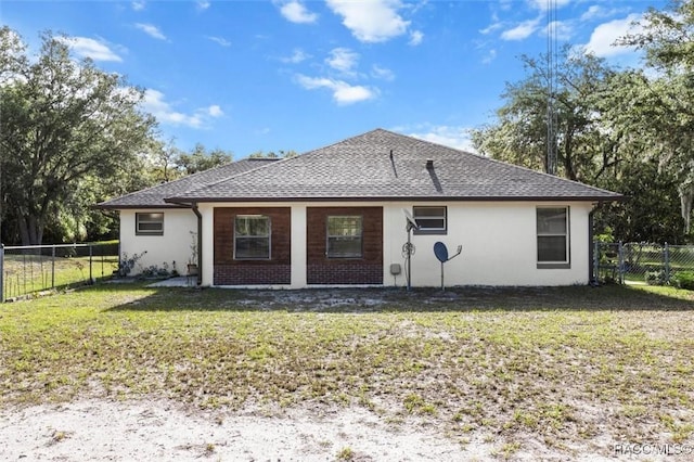back of property featuring a lawn, a fenced backyard, and stucco siding